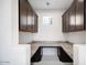 Butler's pantry with granite countertops and dark wood cabinets providing ample storage space at 5710 N 84Th Ave, Glendale, AZ 85305