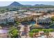 The aerial shot showcases the neighborhood's architecture with views of the distant mountain range at 6257 E Catalina Dr, Scottsdale, AZ 85251