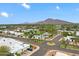 Picturesque aerial view showcasing a community with mature trees, mountain views, and a pool at 6257 E Catalina Dr, Scottsdale, AZ 85251