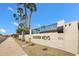 Welcoming community entrance featuring the 'Golden Keys' sign, palm trees, and desert landscaping at 6257 E Catalina Dr, Scottsdale, AZ 85251