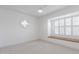 Bright bedroom with white walls, light carpet, and custom windows at 6349 N 78Th St # 123, Scottsdale, AZ 85250