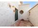 Secluded courtyard featuring unique wall decor and brick flooring at 6349 N 78Th St # 123, Scottsdale, AZ 85250
