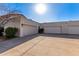 Exterior shot of attached garages with stucco siding and concrete driveways at 6349 N 78Th St # 123, Scottsdale, AZ 85250