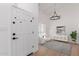 Inviting foyer featuring a statement door, chandelier, and bright interior design at 6349 N 78Th St # 123, Scottsdale, AZ 85250