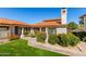Exterior view of a condo with a red tile roof and lush front yard landscaping at 6349 N 78Th St # 123, Scottsdale, AZ 85250