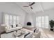 Bright living room featuring vaulted ceilings, fireplace, and light-colored furniture and decor at 6349 N 78Th St # 123, Scottsdale, AZ 85250