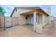 View of the home's back exterior with an extended patio, privacy wall, and neutral paint at 646 W Los Lagos Vista Ave, Mesa, AZ 85210