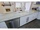 Kitchen island featuring gorgeous countertops, a stainless dishwasher, and modern white cabinets at 646 W Los Lagos Vista Ave, Mesa, AZ 85210