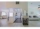 Bright and open living room with neutral walls, a ceiling fan, and a view into the home's kitchen at 646 W Los Lagos Vista Ave, Mesa, AZ 85210