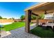 Inviting covered patio and a lush green lawn perfect for outdoor enjoyment at 650 E Daniella E Dr, San Tan Valley, AZ 85140
