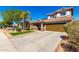 Two-story home featuring a charming front porch, two-car garage, tile roof, and low-maintenance desert landscaping at 650 E Daniella E Dr, San Tan Valley, AZ 85140