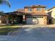 Charming two-story home features a well-manicured lawn and attached two-car garage at 650 E Daniella E Dr, San Tan Valley, AZ 85140