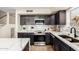 Bright kitchen featuring modern appliances, dark cabinets, and ample countertop space at 650 E Daniella E Dr, San Tan Valley, AZ 85140