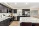 Well-lit kitchen with stainless steel appliances and a spacious island for cooking and entertaining at 650 E Daniella E Dr, San Tan Valley, AZ 85140