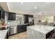 Well-equipped kitchen with stainless steel appliances, dark cabinets and adjacent dining area at 650 E Daniella E Dr, San Tan Valley, AZ 85140