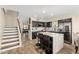 Modern kitchen featuring sleek countertops, stylish island with seating, and stainless steel appliances at 650 E Daniella E Dr, San Tan Valley, AZ 85140
