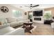 Bright living room with fireplace, large television, ceiling fan, and comfortable seating at 650 E Daniella E Dr, San Tan Valley, AZ 85140