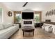 Bright living room featuring a fireplace, TV, modern décor, and an inviting seating area at 650 E Daniella E Dr, San Tan Valley, AZ 85140