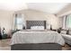 Comfortable main bedroom featuring neutral decor, wood flooring, and lots of natural light at 650 E Daniella E Dr, San Tan Valley, AZ 85140