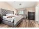Comfortable main bedroom featuring a sitting area, wood flooring, and neutral decor at 650 E Daniella E Dr, San Tan Valley, AZ 85140