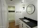 Modern bathroom features sleek black fixtures, a stylish vanity with marble countertop, and a tiled shower/tub combo at 7129 W Meadowbrook Ave, Phoenix, AZ 85033