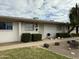 Charming single-story home with white brick exterior, manicured landscaping, and a welcoming front entrance at 7129 W Meadowbrook Ave, Phoenix, AZ 85033