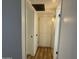 Hallway with storage options, neutral wall color, and access to other rooms at 7129 W Meadowbrook Ave, Phoenix, AZ 85033