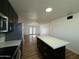 Open kitchen showcases a spacious island, modern appliances, and a seamless transition to the adjacent living area at 7129 W Meadowbrook Ave, Phoenix, AZ 85033