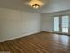 Inviting living room showcases wood floors, neutral walls, and double doors leading to a relaxing patio or outdoor area at 7129 W Meadowbrook Ave, Phoenix, AZ 85033