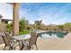 Relaxing backyard features a pool, dining table with chairs and desert landscaping at 8359 E Ingram Cir, Mesa, AZ 85207