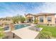 Backyard oasis featuring a pristine pool, lush green grass, and comfortable lounge chairs at 8359 E Ingram Cir, Mesa, AZ 85207