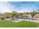 Outdoor pool area with lounge chairs, well-maintained lawn, and desert plants at 8359 E Ingram Cir, Mesa, AZ 85207