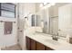 Bathroom featuring a single sink vanity with brown cabinets and a large mirror at 8359 E Ingram Cir, Mesa, AZ 85207