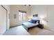 Modern bedroom with neutral walls, carpet floors, a large window, and a comfortable queen size bed at 8359 E Ingram Cir, Mesa, AZ 85207
