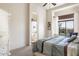 Bright bedroom with a comfy bed, window view, and ensuite bathroom access at 8359 E Ingram Cir, Mesa, AZ 85207
