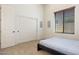 Simple bedroom includes a bed, large closet, and a window with wood blinds at 8359 E Ingram Cir, Mesa, AZ 85207