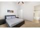 Neutral bedroom with a ceiling fan, carpet and view into the bathroom at 8359 E Ingram Cir, Mesa, AZ 85207