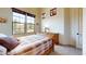 Bedroom features natural light, a window with outdoor views, a wooden bed, and a dresser at 8359 E Ingram Cir, Mesa, AZ 85207