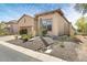 A tan stucco home with desert landscaping including a cactus and rock drainage at 8359 E Ingram Cir, Mesa, AZ 85207