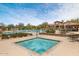 Community hot tub with tile trim, surrounded by lounge chairs, in an outdoor setting at 8359 E Ingram Cir, Mesa, AZ 85207
