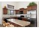 Modern kitchen featuring granite countertops, stainless steel appliances, and wood cabinetry at 8359 E Ingram Cir, Mesa, AZ 85207