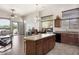 Open-concept kitchen with a granite island, stainless steel appliances, and a cozy breakfast nook at 8359 E Ingram Cir, Mesa, AZ 85207