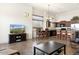 Open-concept living area with dining space, kitchen, and natural light through multiple windows at 8359 E Ingram Cir, Mesa, AZ 85207