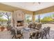 Outdoor seating area featuring a stone fireplace and comfortable cushioned chairs at 8359 E Ingram Cir, Mesa, AZ 85207