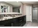 Bathroom featuring double sinks, granite countertops, a large mirror, and a walk-in shower at 8369 E Del Camino Dr, Scottsdale, AZ 85258