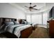 Bright bedroom featuring two beds, tray ceilings, and large windows with plantation shutters at 8369 E Del Camino Dr, Scottsdale, AZ 85258