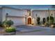 Charming home featuring a custom wood door, desert landscaping, and a two-car garage at 8369 E Del Camino Dr, Scottsdale, AZ 85258