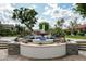 Beautiful tiered fountain surrounded by manicured landscaping and mature trees in a community at 8369 E Del Camino Dr, Scottsdale, AZ 85258