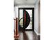Stunning modern front door with textured glass, a unique circle design, and a stylish wooden handle at 8369 E Del Camino Dr, Scottsdale, AZ 85258