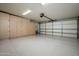 Spacious garage with ample storage cabinets and epoxy floor at 8369 E Del Camino Dr, Scottsdale, AZ 85258
